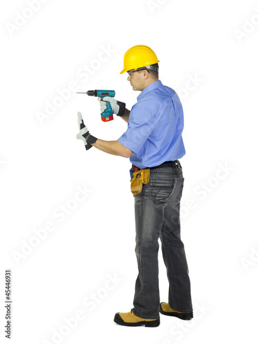 man in safety gears holding electric drill machine