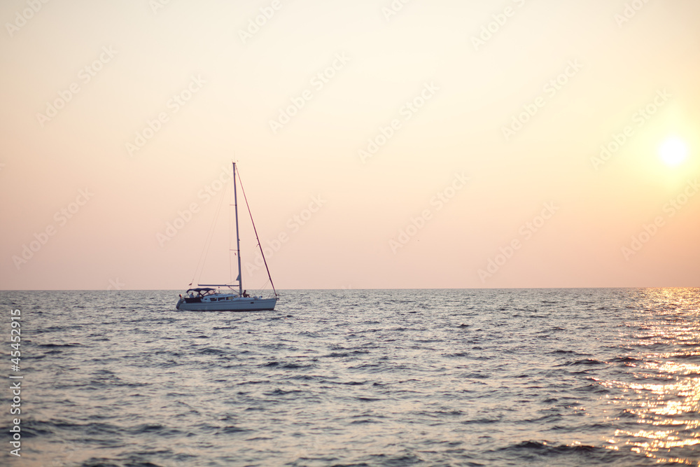 yacht at sea in sunset