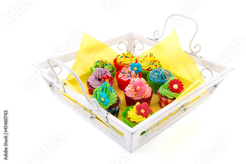 Colorful cupcakes on wooden tray