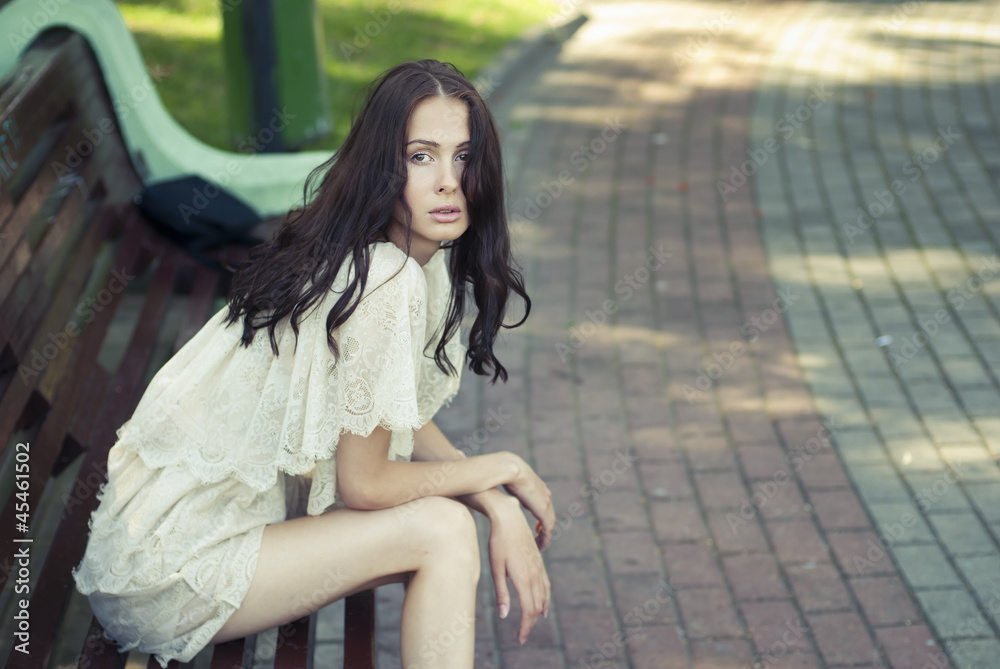 Beautiful girl sitting on a bench