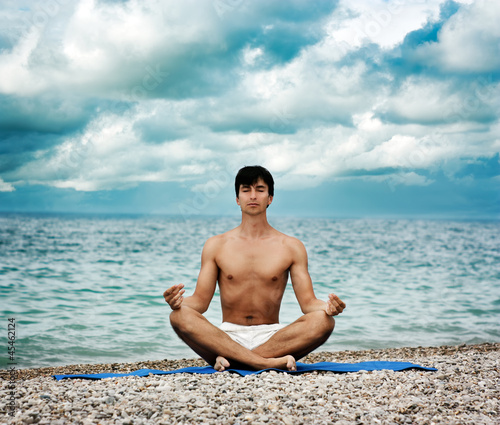 Man Doing Yoga near the Sea