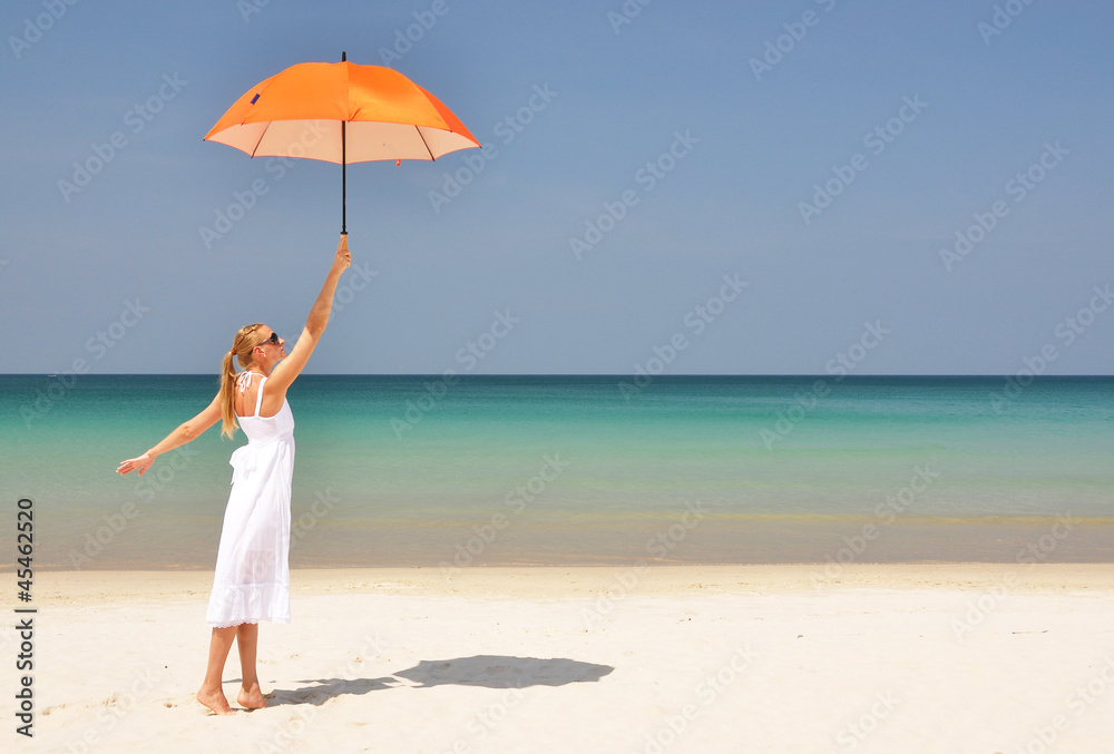 Girl with an orange umbrella on the tropical beach Girl with an orange umbrella on the tropical beach