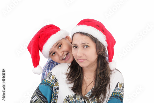 Cheerful boy and woman in Santa Claus hat. Isolated on white bac