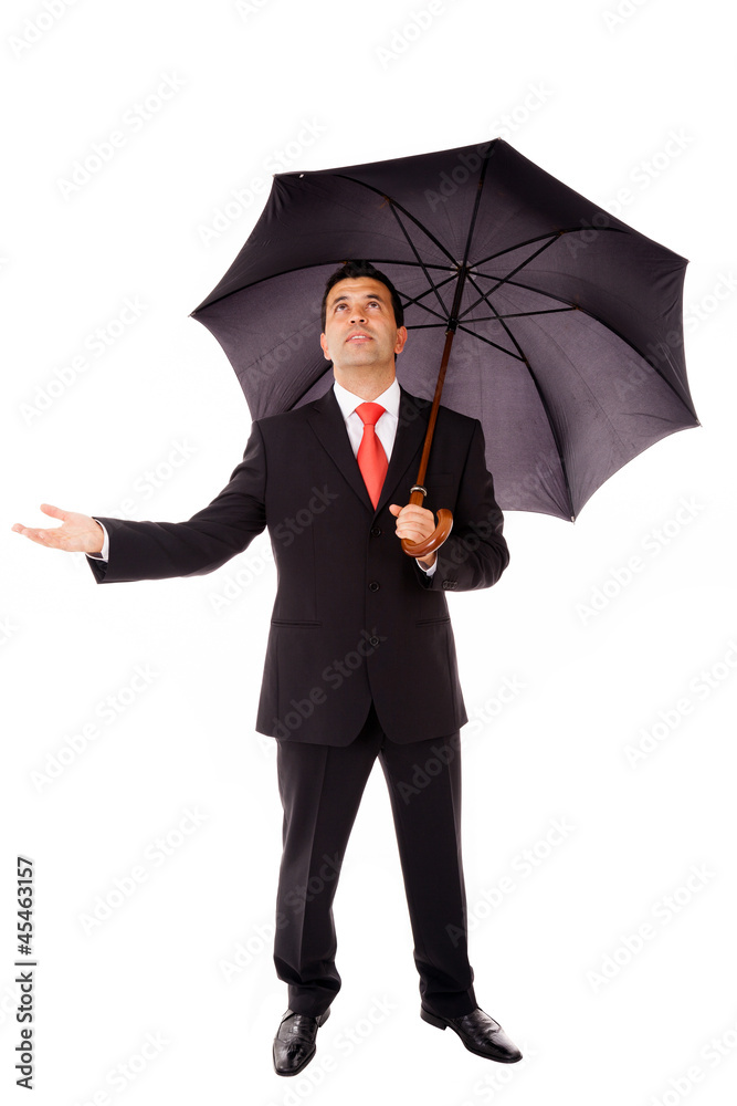 Full body of young business man with umbrella checking if it's r Full body of young business man with umbrella checking if it's r