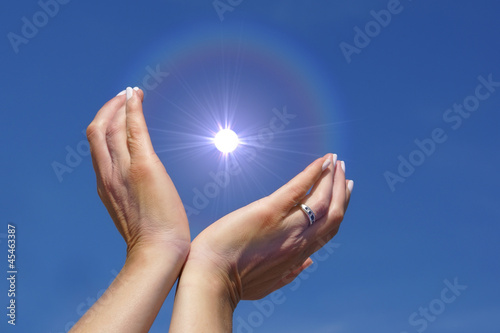 Woman hands protecting energy spark