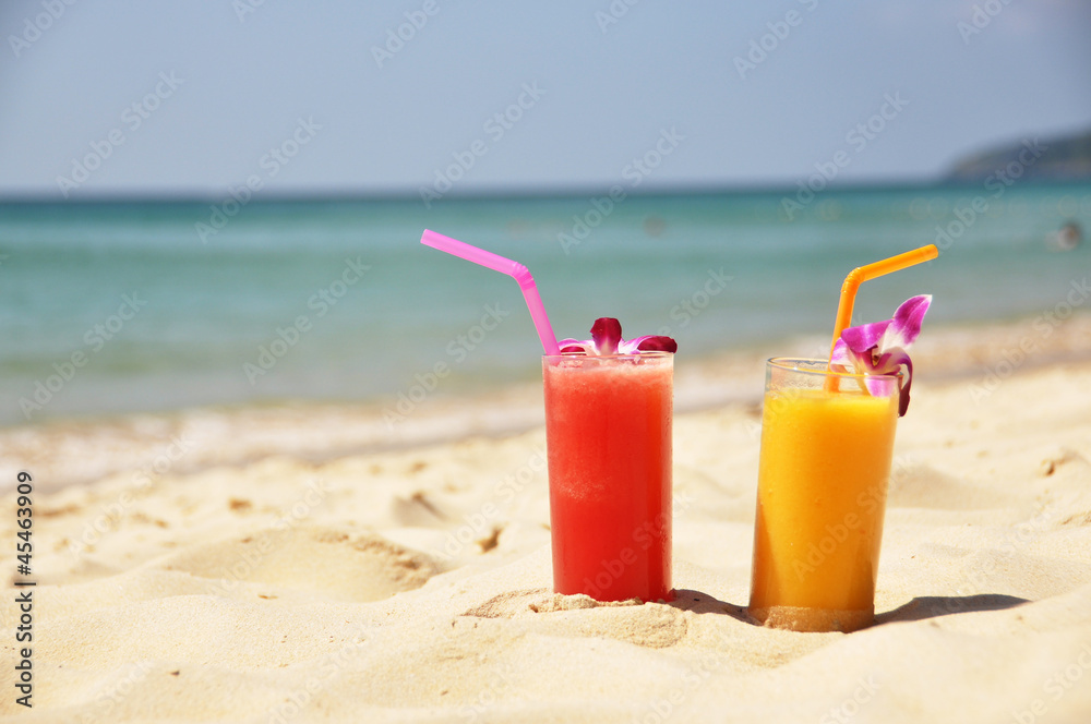 Pair of fruit shakes on the tropical beach Pair of fruit shakes on the tropical beach
