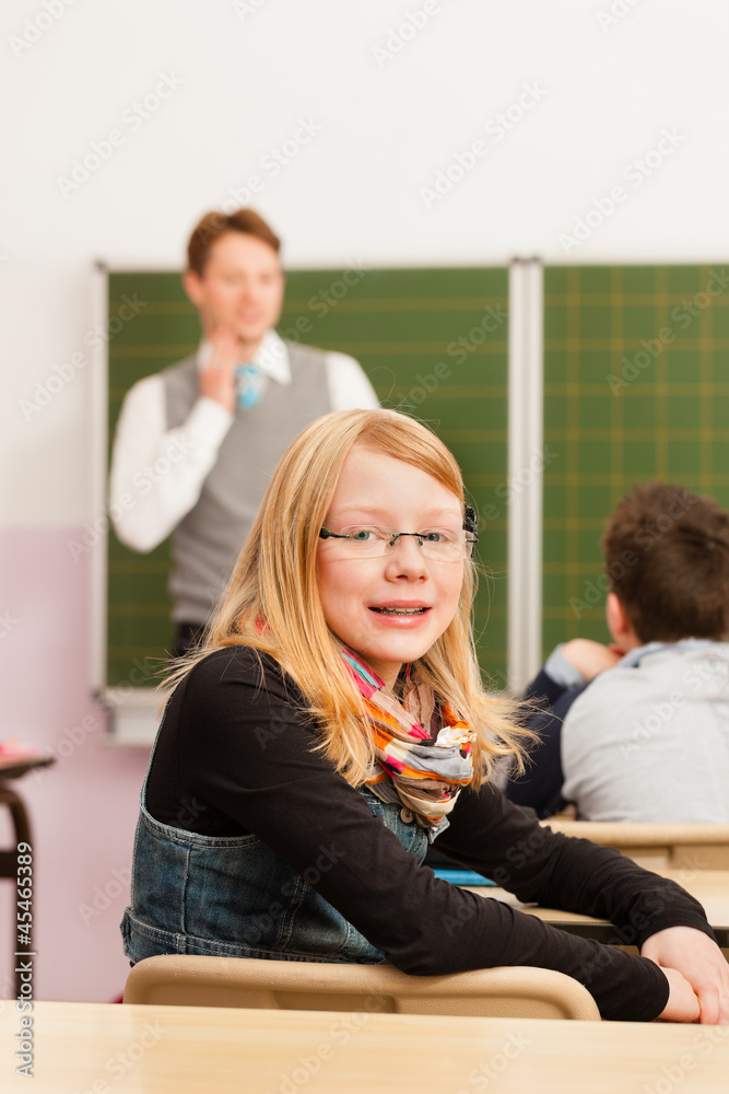 Education - Teacher with pupil in school teaching Education - Teacher with pupil in school teaching