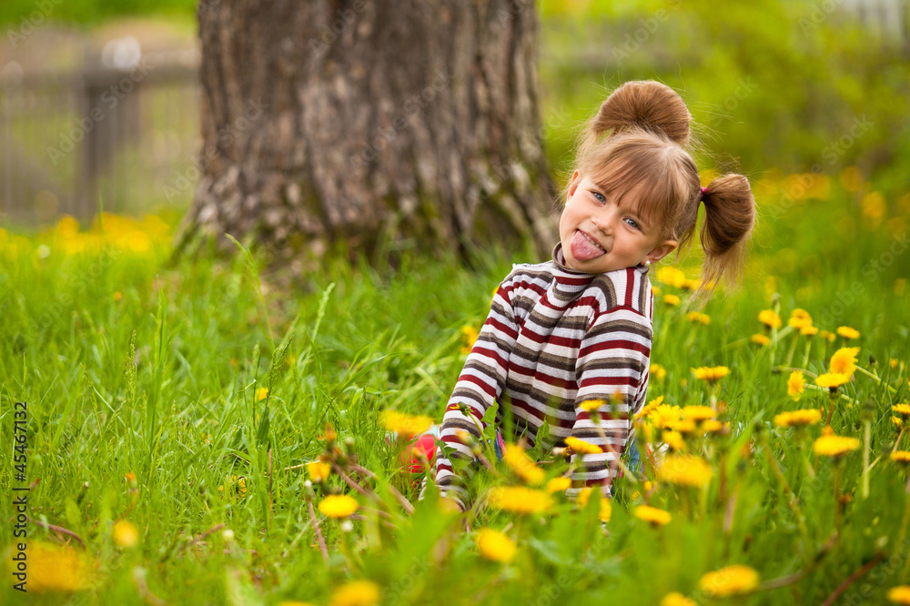 Little lovely girl playing in the park, shows the language Little lovely girl playing in the park, shows the language