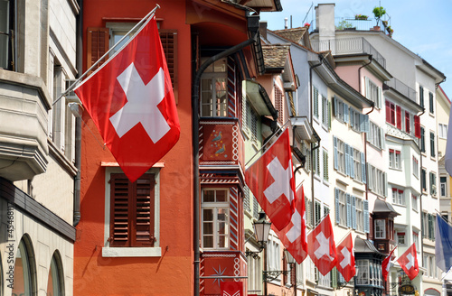 Old street in Zurich decorated with flags for the Swiss National