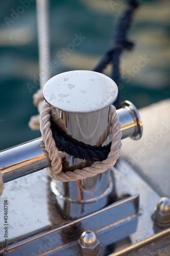 Sailboat detailed parts, close up on winch and rope of yacht