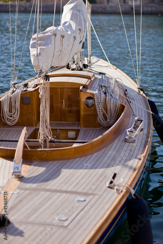 beautiful wooden sailboat on blue sea ocean