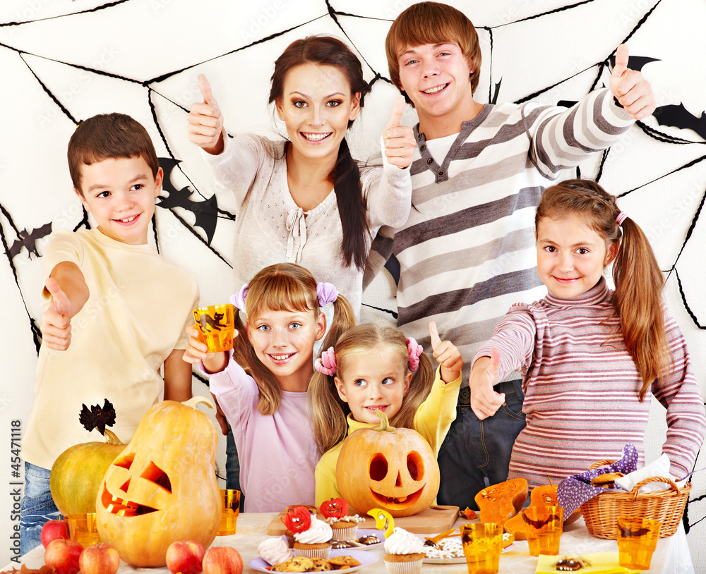 Family  with child holding make carved pumpkin