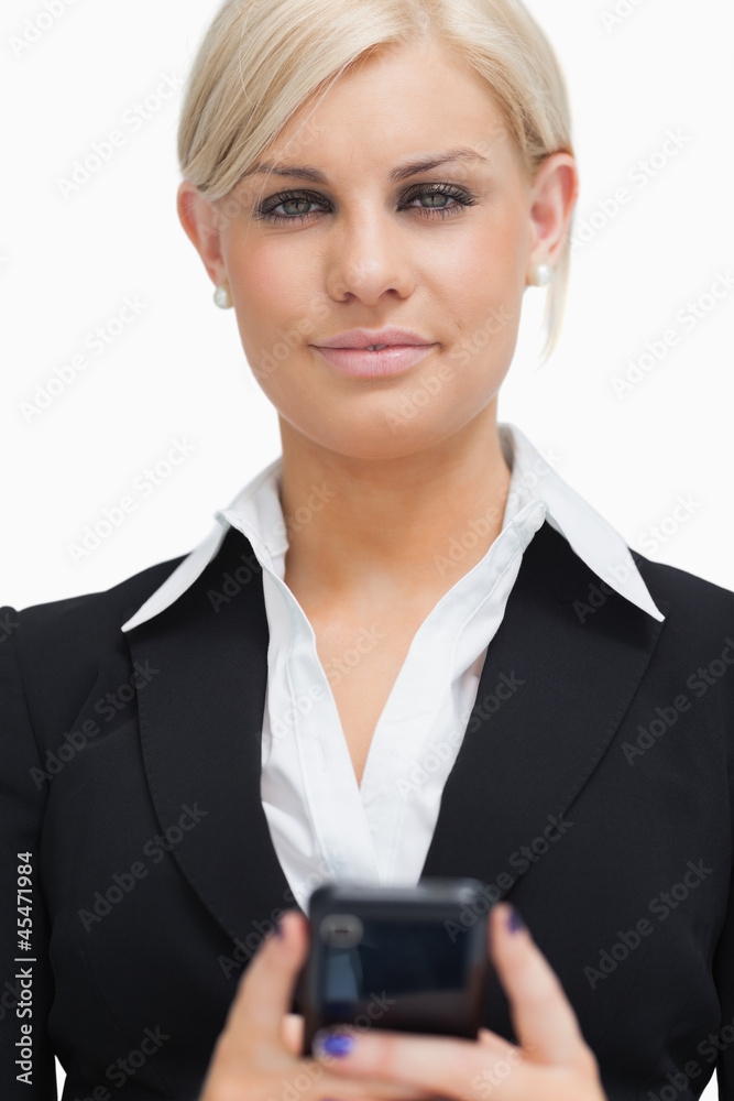 Businesswoman holding her mobile phone Businesswoman holding her mobile phone