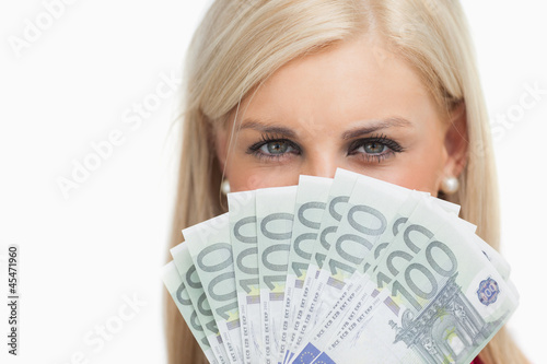 Pretty blonde holding 100 euros banknotes