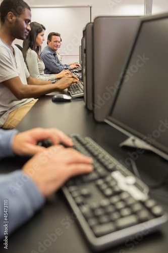 Mature student looking up from computer class