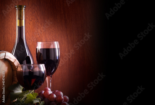 Red wine glass and Bottle on a wooden background