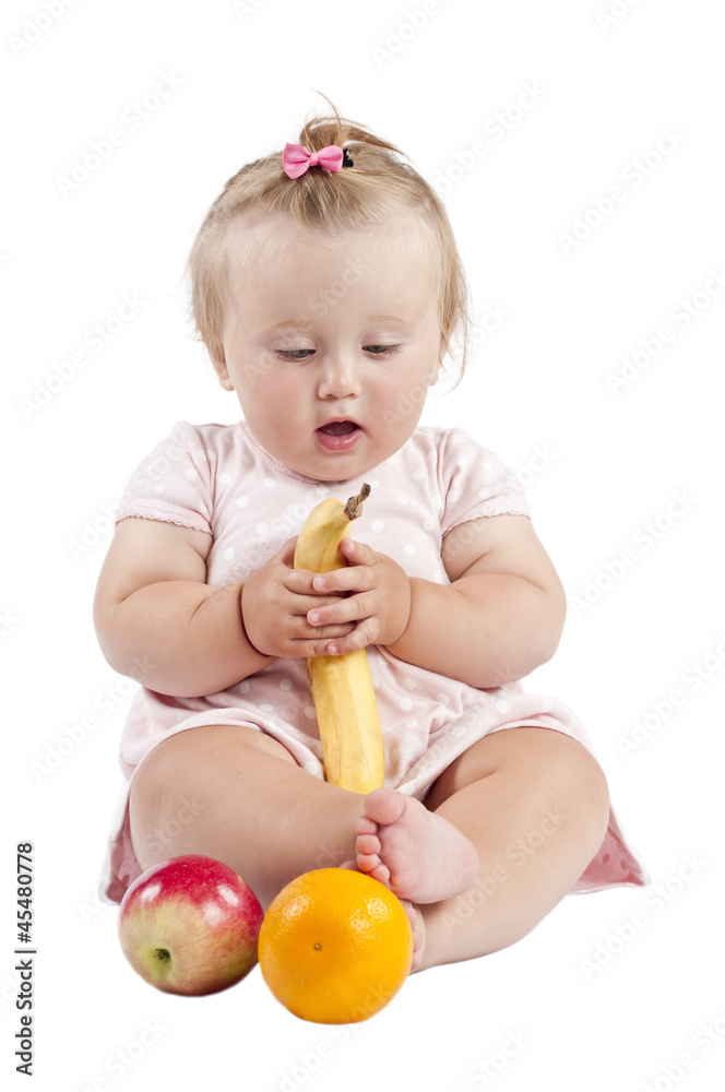small child with an orange and a banana small child with an orange and a banana