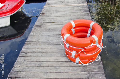 life buoy on wooden resort lake bridge photo