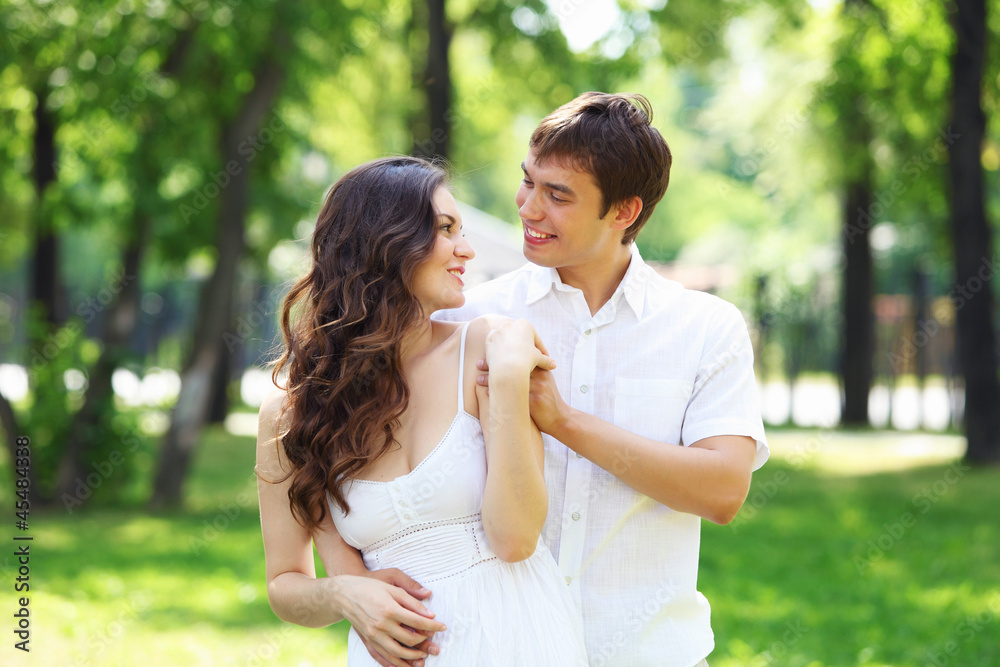 Young love Couple smiling under blue sky Young love Couple smiling under blue sky