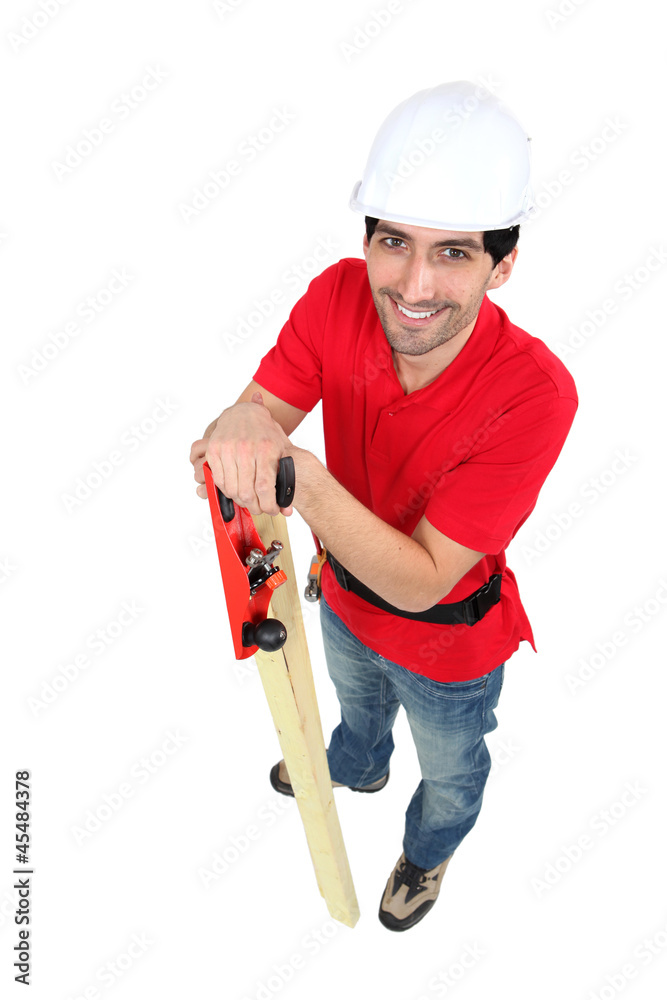 craftsman holding a wooden board and a rasp craftsman holding a wooden board and a rasp