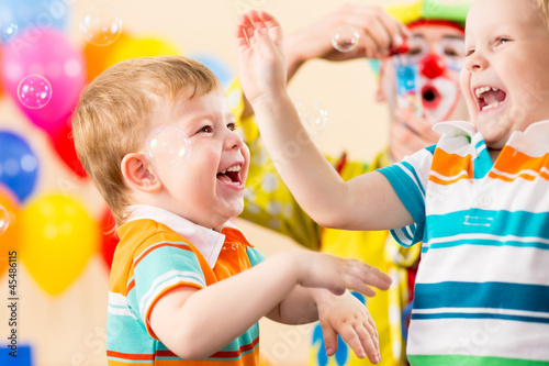 joyful kids with clown on birthday party