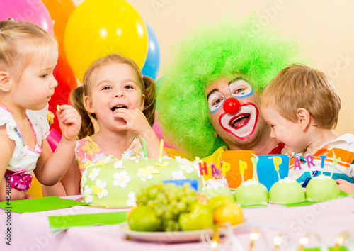 kids celebrating birthday party with clown