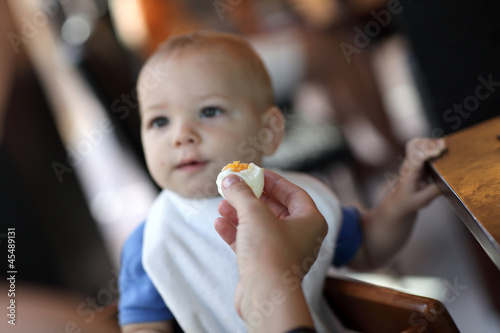 Toddler eating boiled egg