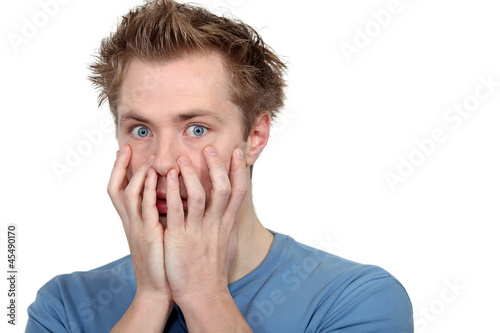 Young covering his face with his hands