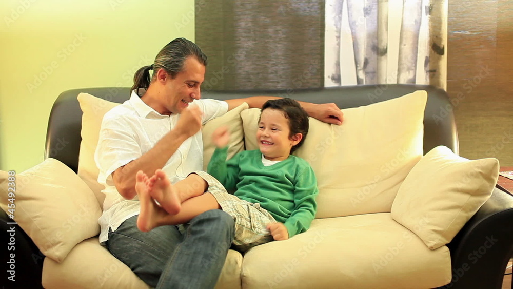 father and son playin playing paper stone scissors