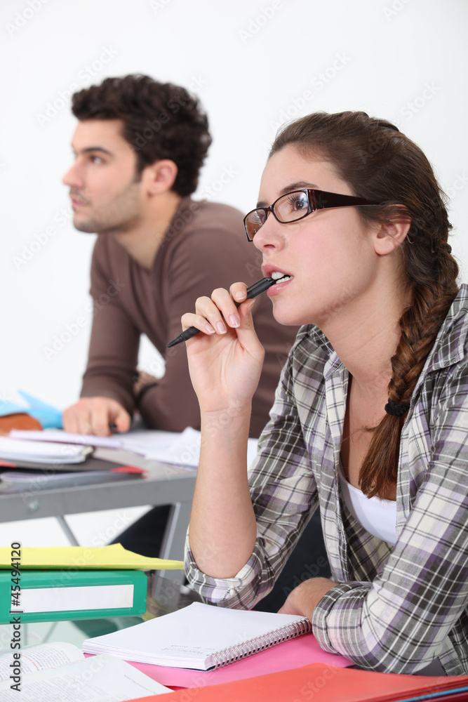 Two students concentrating in class Two students concentrating in class