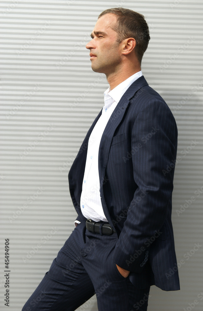 Photography Man posing against a striped wall