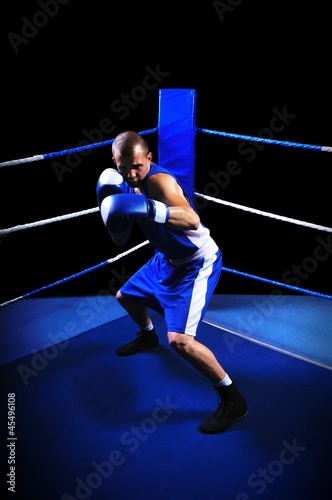 Male boxer in ring doing exercise