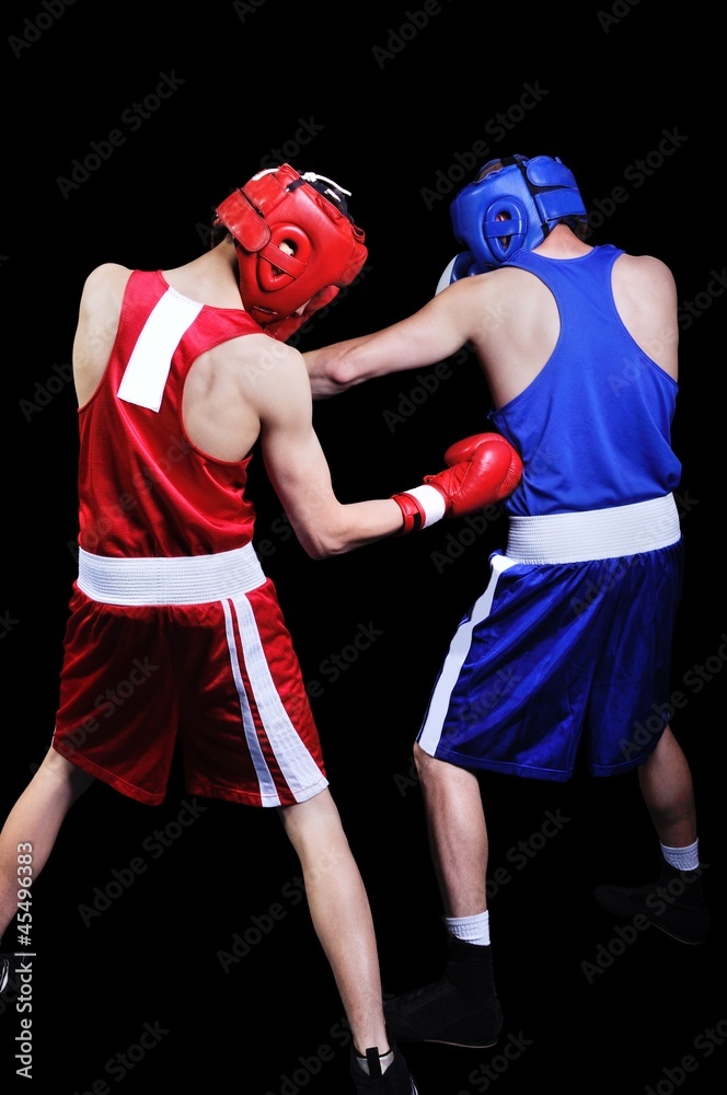 Two male boxers fighting on black background
