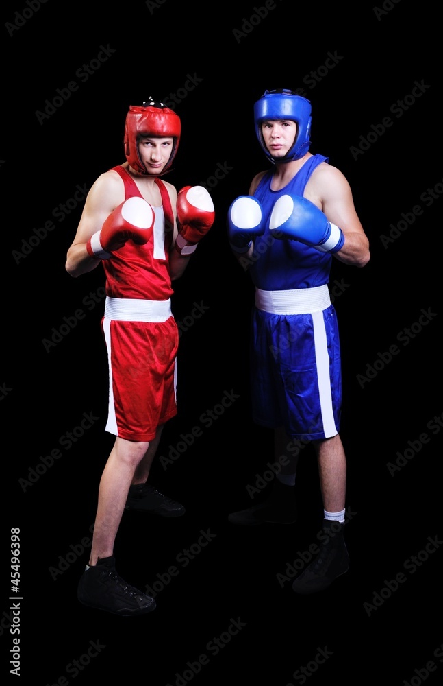 Obraz premium Two male boxers fighting on black background