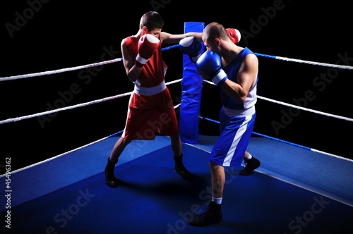 Two male boxers fighting in ring