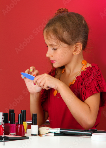 little girl in her mother's...