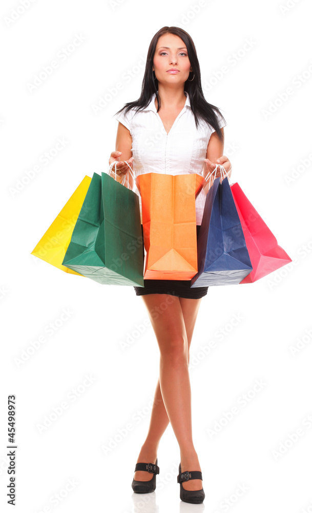 Portrait of young woman carrying shopping bags against white bac Portrait of young woman carrying shopping bags against white bac