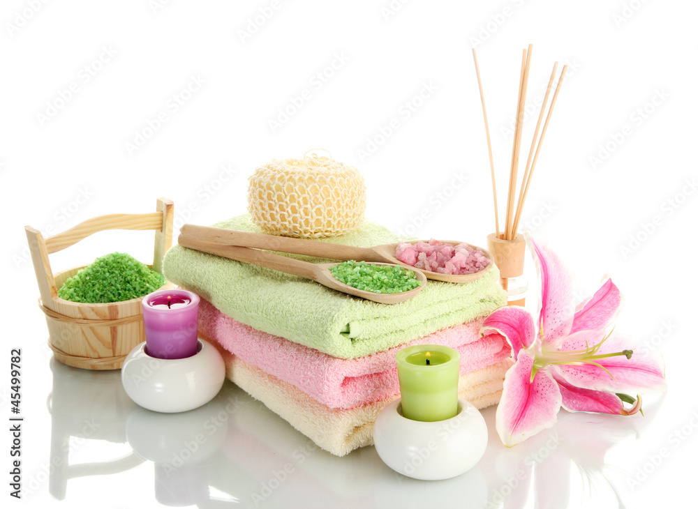 towels with lily, aroma oil, candles and sea salt isolated towels with lily, aroma oil, candles and sea salt isolated