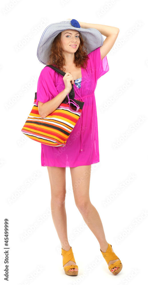 A smiling beautiful girl with beach hat and beach bag isolated A smiling beautiful girl with beach hat and beach bag isolated