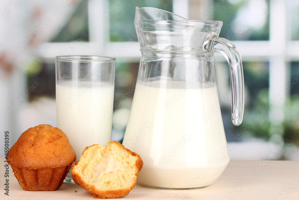Pitcher and glass of milk with muffins Pitcher and glass of milk with muffins