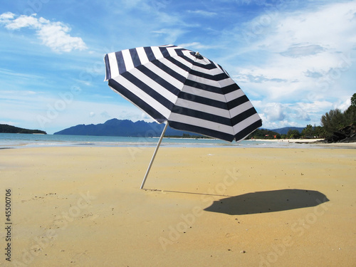 Photography Striped umbrella on a sandy beach of Langkawi island