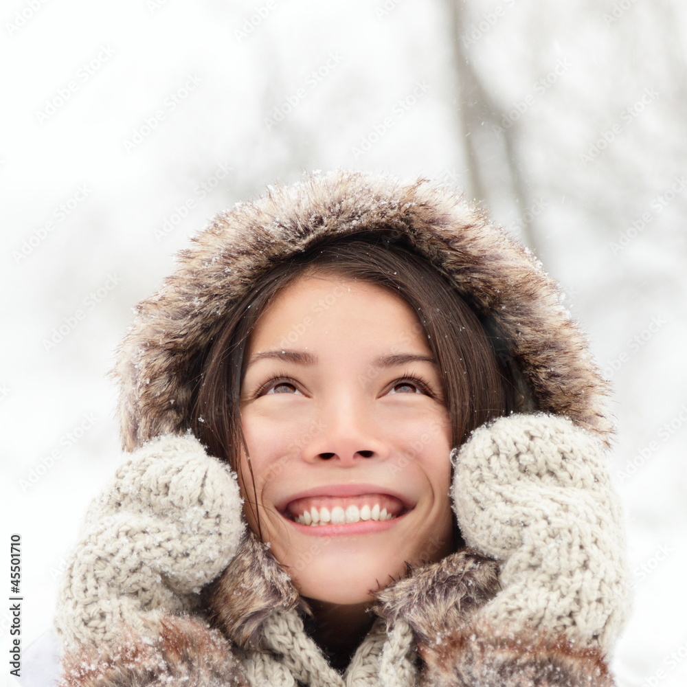 Winter woman looking up happy and smiling Winter woman looking up happy and smiling