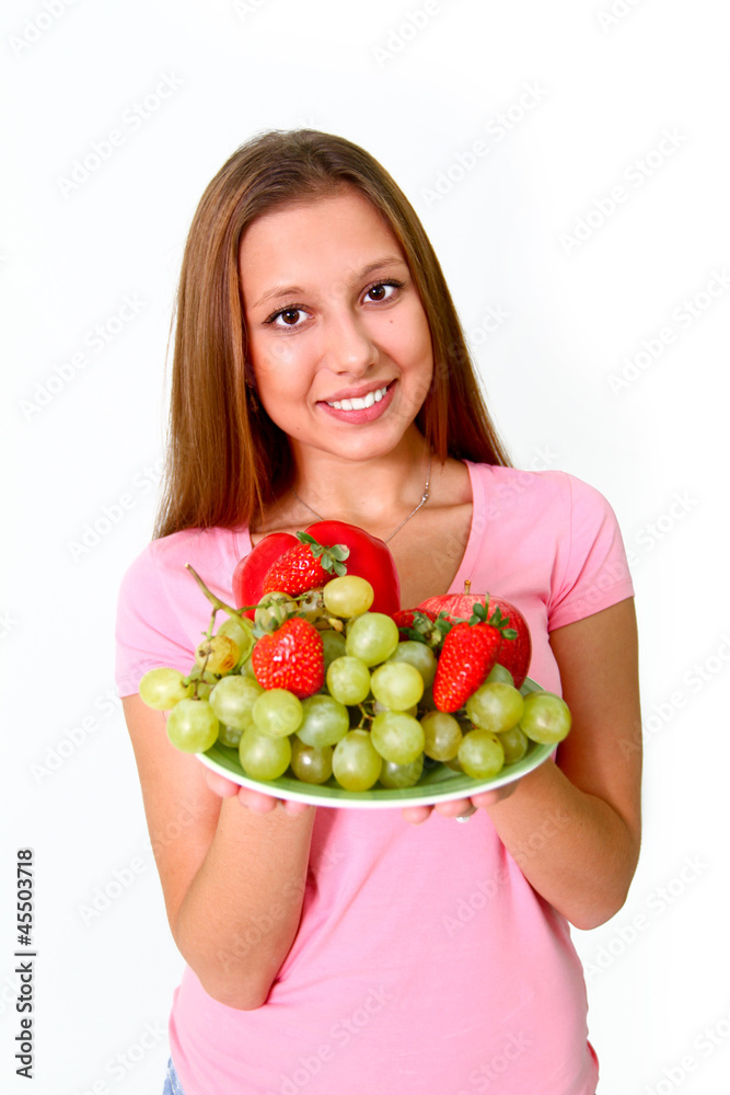 Young woman with fruits and vegetables on a dish Young woman with fruits and vegetables on a dish