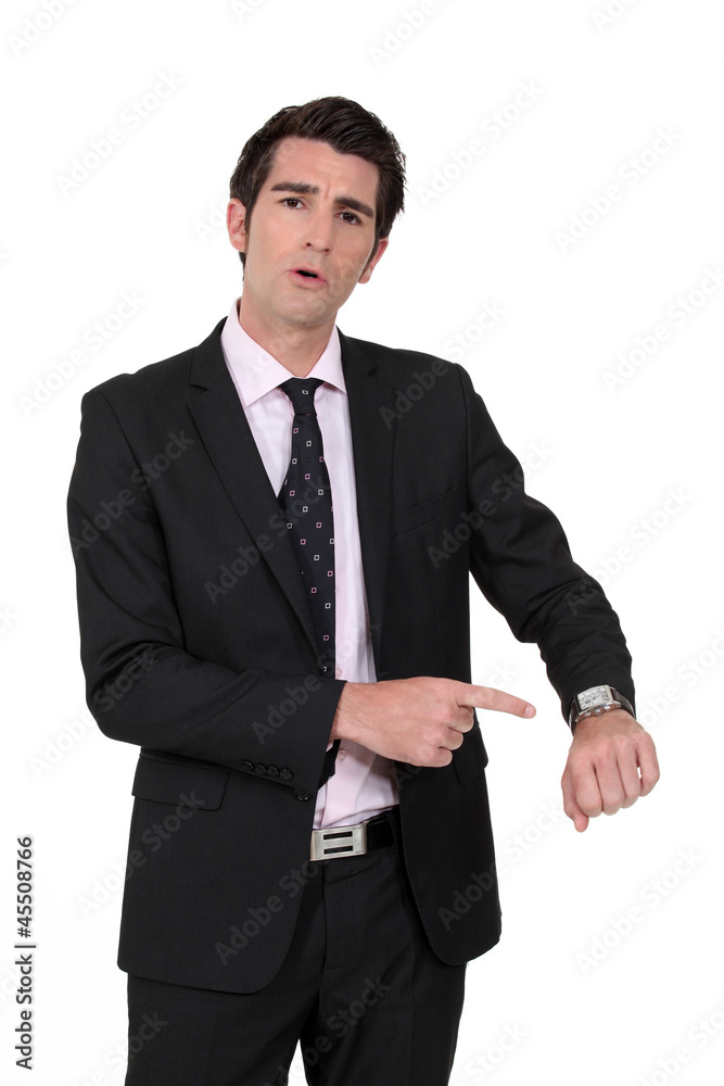Businessman pointing at his watch Businessman pointing at his watch