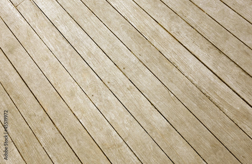 Weathered wooden decking planks close up.