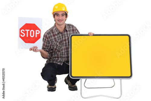 Worker with a blank road sign