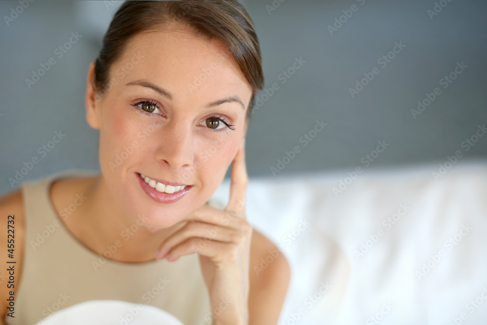 Portrait of attractive woman sitting in couch Portrait of attractive woman sitting in couch