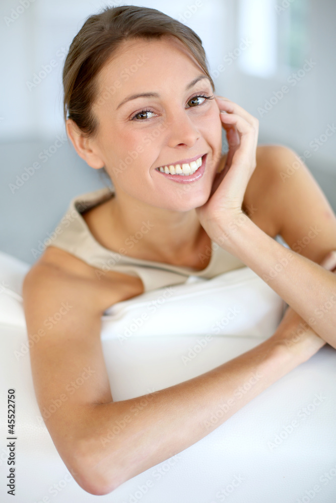 Beautiful smiling woman relaxing in sofa Beautiful smiling woman relaxing in sofa