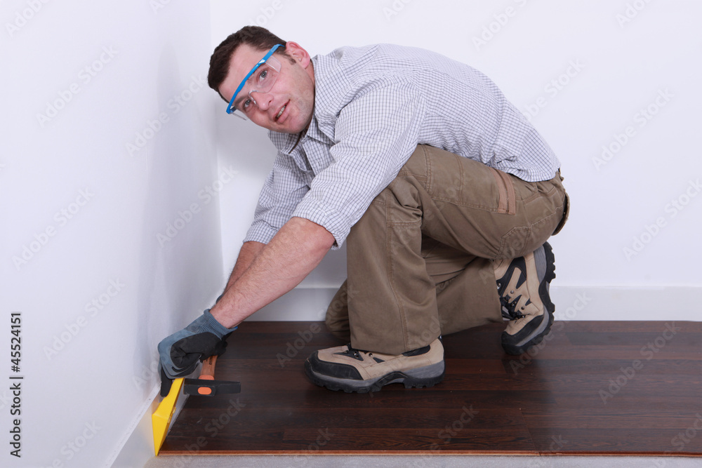 Man laying a new parquet. Man laying a new parquet.
