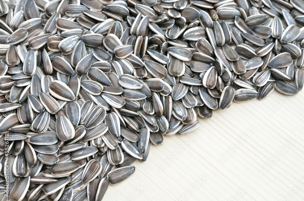 Grains of sunflower seed on wood background Grains of sunflower seed on wood background